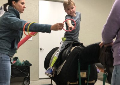 child riding equicizer in office